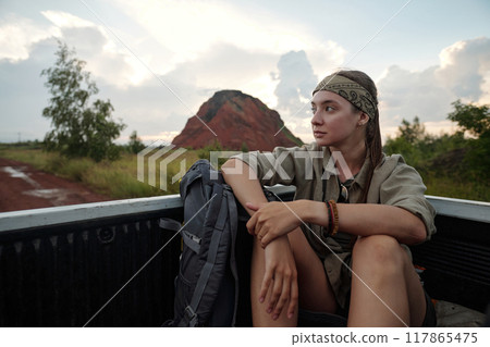 Traveler riding in body of pickup truck Traveler riding in body of pickup truck 117865475