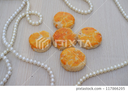 peanut cookies with white pearls on a wooden background, top view peanut cookies with white pearls on a wooden background, top view 117866205
