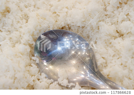 Close up of white rice with spoon in the kitchen. Selective focus Close up of white rice with spoon in the kitchen. Selective focus 117866628