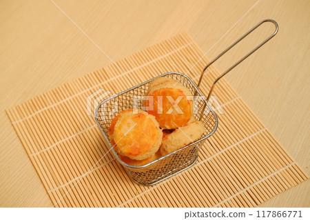 cookies in metal basket on bamboo mat background. cookies in metal basket on bamboo mat background. 117866771