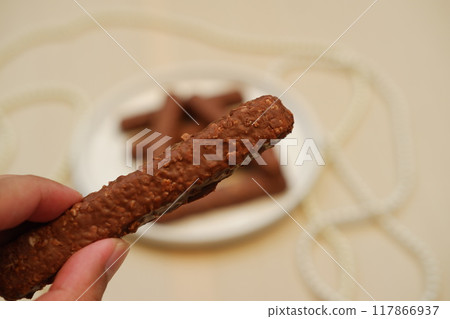 Chocolate wafers on a white plate, close-up 117866937