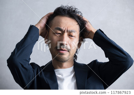 Businessman holding his head Businessman holding his head 117867923