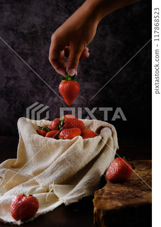 red ripe strawberries on a dark background red ripe strawberries on a dark background 117868523