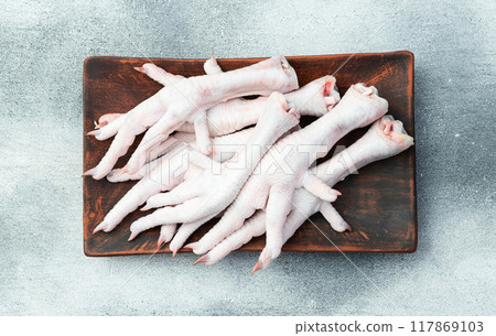 Raw chicken foot ( paws ) Top view on rustic background Raw chicken foot ( paws ) Top view on rustic background 117869103