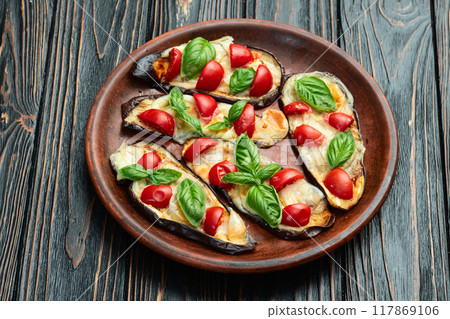 Italian mini pizza . Aubergine (eggplant ) with mozzarella cheese and basil . On rustic background 117869106