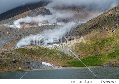Smoke billowing from the slopes of a volcano 117869202