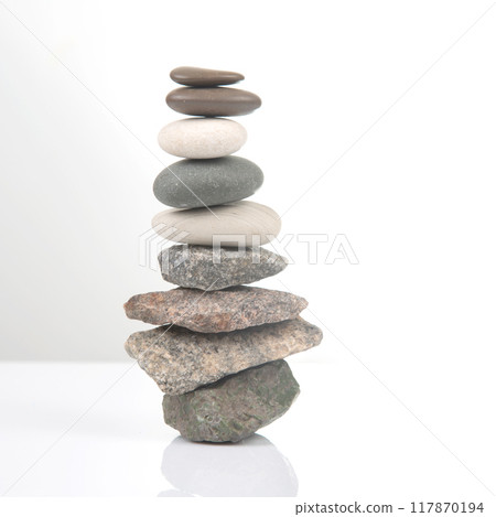 pyramid of stacked stones on a white background. stabilization and balance in life 117870194