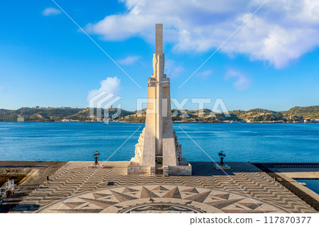 Monument to Discoveries or Padrao dos Descobrimentos to Age of Discovery, shaped as sword on one side, with statues of great people of Portuguese seafarers history, Lisbon, Portugal, at clear blue sky 117870377
