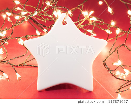 Ceramic Christmas decoration. Christmas ornament on the Christmas lights background. Ceramic Christmas decoration. Christmas ornament on the Christmas lights background. 117871637