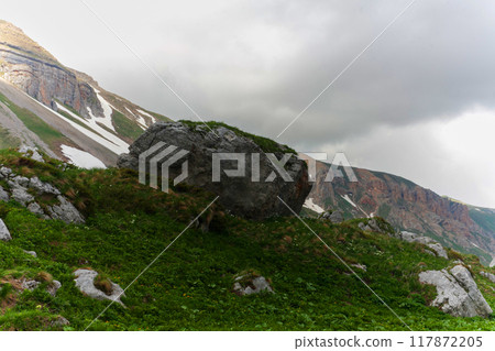 A Mountain Boulder Under Cloudy Skies A Mountain Boulder Under Cloudy Skies 117872205