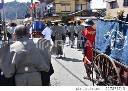 Takayama City, Gifu Prefecture, Japan: Spring Takayama Festival: People participating in the Daimyo Procession. Back view of a man wearing a kimono and carrying a cart. Takayama City, Gifu Prefecture, Japan: Spring Takayama Festival: People participating in the Daimyo Procession. Back view of a man wearing a kimono and carrying a cart. 117873743
