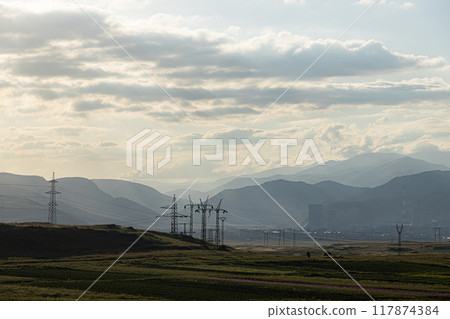 Armenian Power Plant Silhouetted Against a Hazy Mountain Range 117874384
