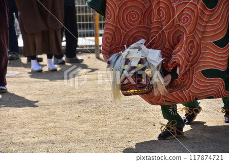 Takayama City, Gifu Prefecture, Japan: Traditional performing arts at the Takayama Spring Festival. Lion dance dedicated to the shrine. People wearing festival costumes and shaking the lion's face. Takayama City, Gifu Prefecture, Japan: Traditional performing arts at the Takayama Spring Festival. Lion dance dedicated to the shrine. People wearing festival costumes and shaking the lion's face. 117874721
