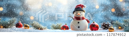 Snowman standing in snow with christmas ornaments and falling snow 117874912