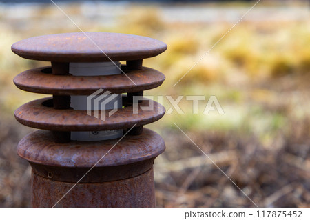 Rusty Industrial Vent in Overgrown Field on a Misty Autumn Morning Rusty Industrial Vent in Overgrown Field on a Misty Autumn Morning 117875452