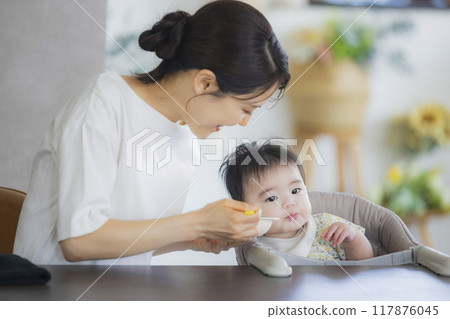 Baby eating baby food 117876045