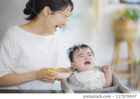 Baby eating baby food 117876047