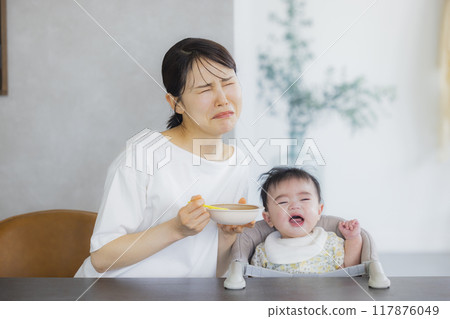 Baby eating baby food Baby eating baby food 117876049