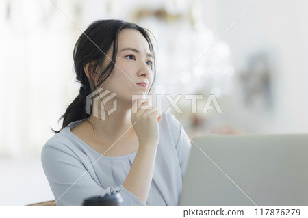 Young woman working remotely Young woman working remotely 117876279