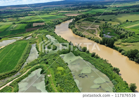 Aerial view of river gravel and sand ballast open pit mining abandoned lake 117876516