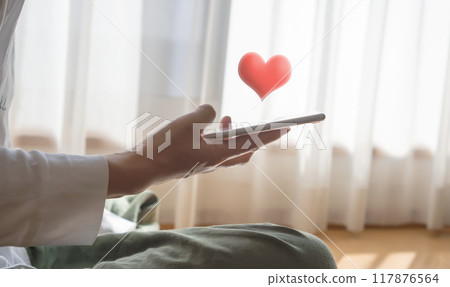 A woman watching a smaho in a room 117876564