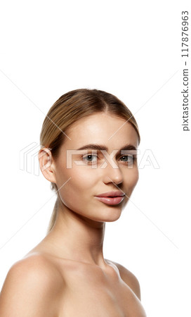 Benefits of advanced skin care and high-quality cosmetics. Portrait of attractive young woman with well-kept clear skin, isolated on white studio background 117876963