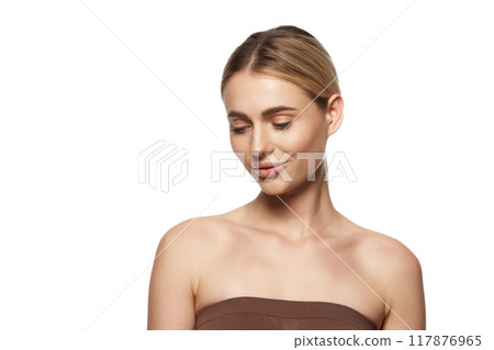 Young woman with perfect, clear skin, reflecting success of skin care and cosmetic treatments, isolated on white studio background Young woman with perfect, clear skin, reflecting success of skin care and cosmetic treatments, isolated on white studio background 117876965