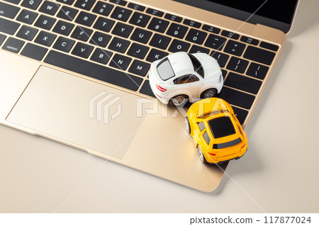 Car on laptop on gold background, online buying, selling car, auto insurance Car on laptop on gold background, online buying, selling car, auto insurance 117877024