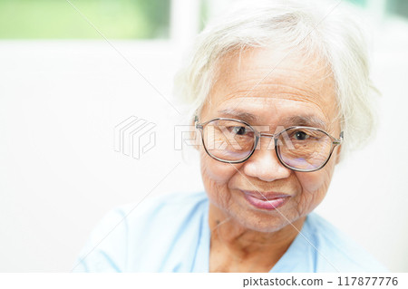 Asian senior woman wearing eyeglasses or vision glasses at home care service. 117877776