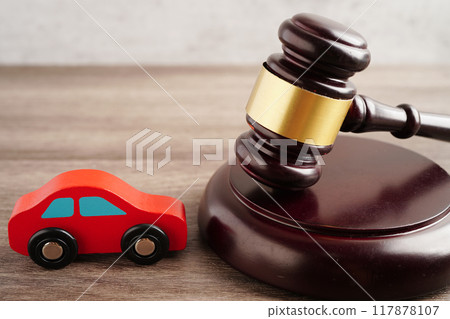 Car accident lawsuit and insurance, Judge hammer with car model. 117878107