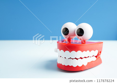 Funny red teeth with eye toy denture model for dental health care. 117878224
