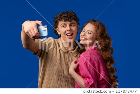 Happy couple talking camera as video call,record vlog as bloggers on blue wall 117878477