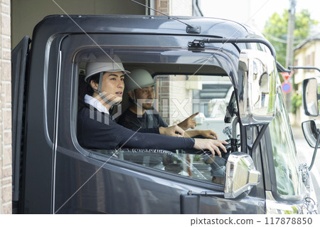Workers working on a truck 117878850