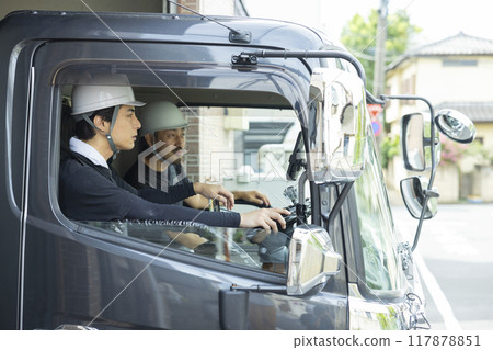 Workers working on a truck 117878851