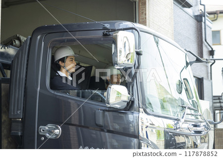Workers working on a truck 117878852