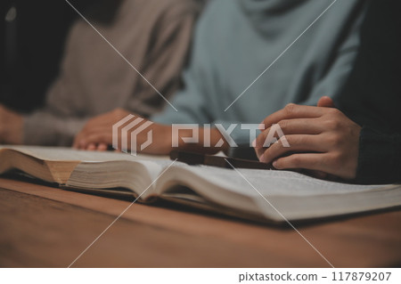 Christian group are praying to god with the bible and sharing the gospel. Concept of faith for god. Christian group are praying to god with the bible and sharing the gospel. Concept of faith for god. 117879207