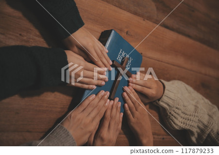 Christian group are praying to god with the bible and sharing the gospel. Concept of faith for god. Christian group are praying to god with the bible and sharing the gospel. Concept of faith for god. 117879233