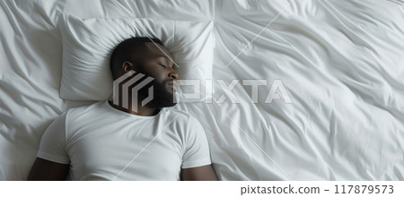 Peaceful african american man sleeping on white bed with copy space 117879573