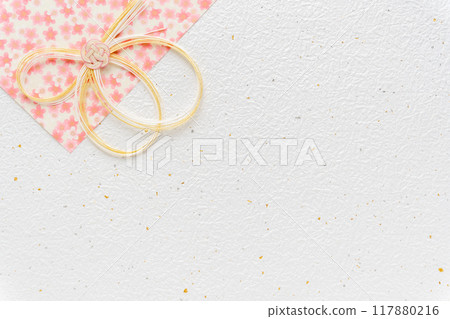 Pink cherry blossom patterned washi paper and mizuhiki background material on white background Pink cherry blossom patterned washi paper and mizuhiki background material on white background 117880216