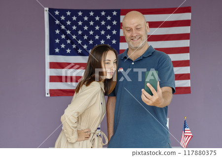 People Making Selfie Portrait Against American Flag 117880375
