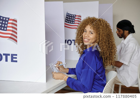 Woman Voting For Candidate In Booth Woman Voting For Candidate In Booth 117880405