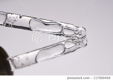 Pipette with cosmetic gel or serum close-up. 117880408