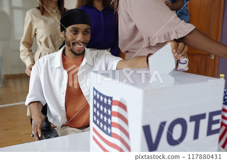 Man Putting Bulletin In Box Man Putting Bulletin In Box 117880431