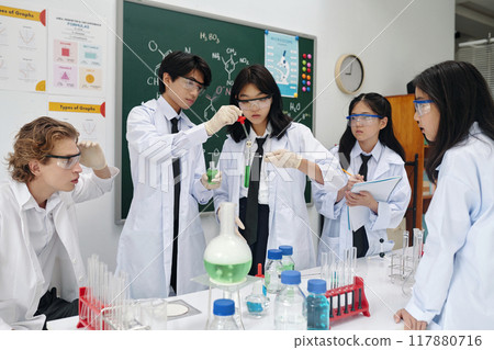 Students Engaging in Chemistry Experiment in Laboratory Students Engaging in Chemistry Experiment in Laboratory 117880716