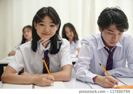 Students Focusing on Exam Preparation in Classroom 117880799