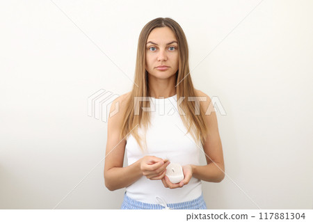 Frustrated young woman with hair loss problem holds hair brush and shows on bunch of fallen hair after combing. Alopecia, endocrine disorder, hormonal imbalance, postpartum period, stress concept Frustrated young woman with hair loss problem holds hair brush and shows on bunch of fallen hair after combing. Alopecia, endocrine disorder, hormonal imbalance, postpartum period, stress concept 117881304