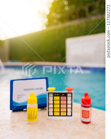PH tester for pool maintenance. Water test kit for swimming pools, Chlorine and ph tester for swimming pools. Chlorine test kit on the edge of the pool 117882272