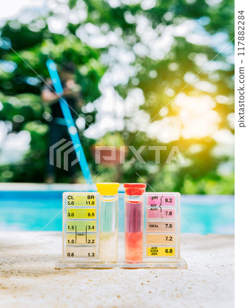 Pool water PH tester kit on the edge of the swimming pool. Tester kit to measure chlorine and ph in swimming pools Pool water PH tester kit on the edge of the swimming pool. Tester kit to measure chlorine and ph in swimming pools 117882284