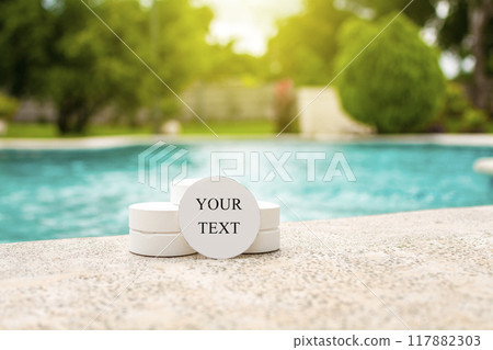 Chlorine tablets for swimming pool disinfection with space for text. Chlorine tablets for swimming pool cleaning with space for text, chlorine tablets on the edge of a swimming pool Chlorine tablets for swimming pool disinfection with space for text. Chlorine tablets for swimming pool cleaning with space for text, chlorine tablets on the edge of a swimming pool 117882303