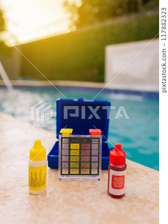 Chlorine test kit on the edge of the swimming pool Mini tester for pool maintenance. Water test kit for swimming pools, Chlorine and ph tester for swimming pools Chlorine test kit on the edge of the swimming pool Mini tester for pool maintenance. Water test kit for swimming pools, Chlorine and ph tester for swimming pools 117882323
